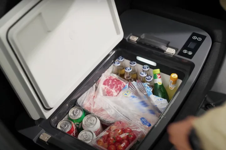 An open cooler in the trunk of a Tesla showing a range of groceries