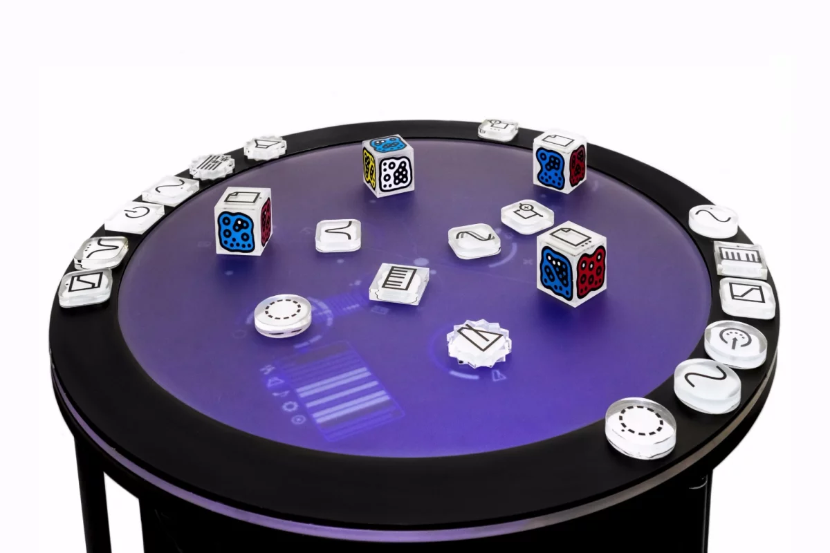 Music creation with the Live! S6 modular synth involves the placement and manipulation of transparent blocks on the upper surface of the table