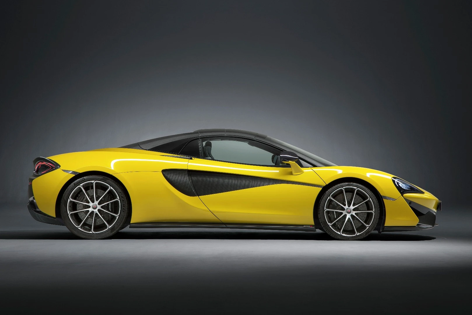 The McLaren 570S Spider has a coupe-style roofline with the roof up