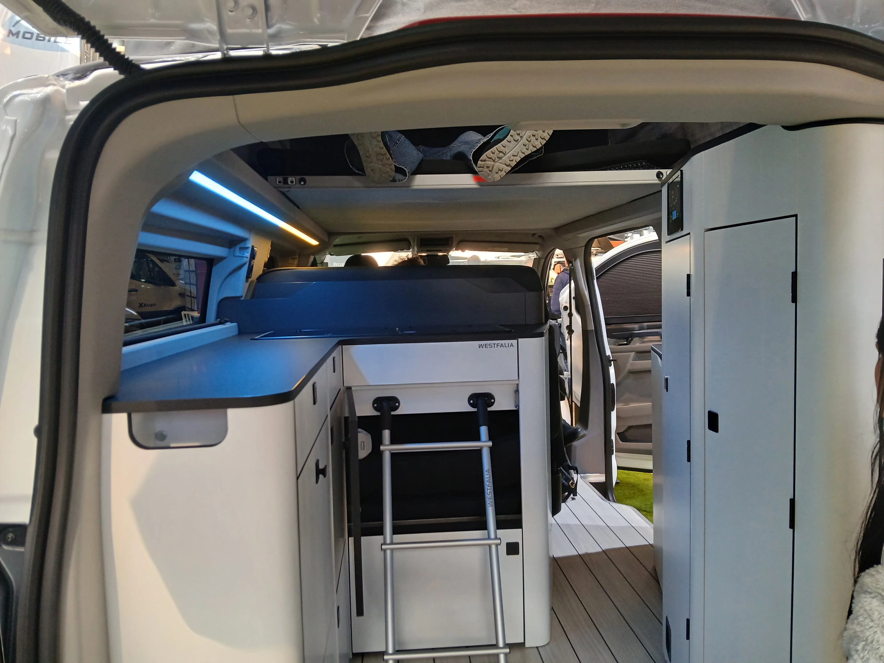 The small half-ladder lets campers climb up into the double bed in the pop-up roof, after lowering the bed to nighttime position