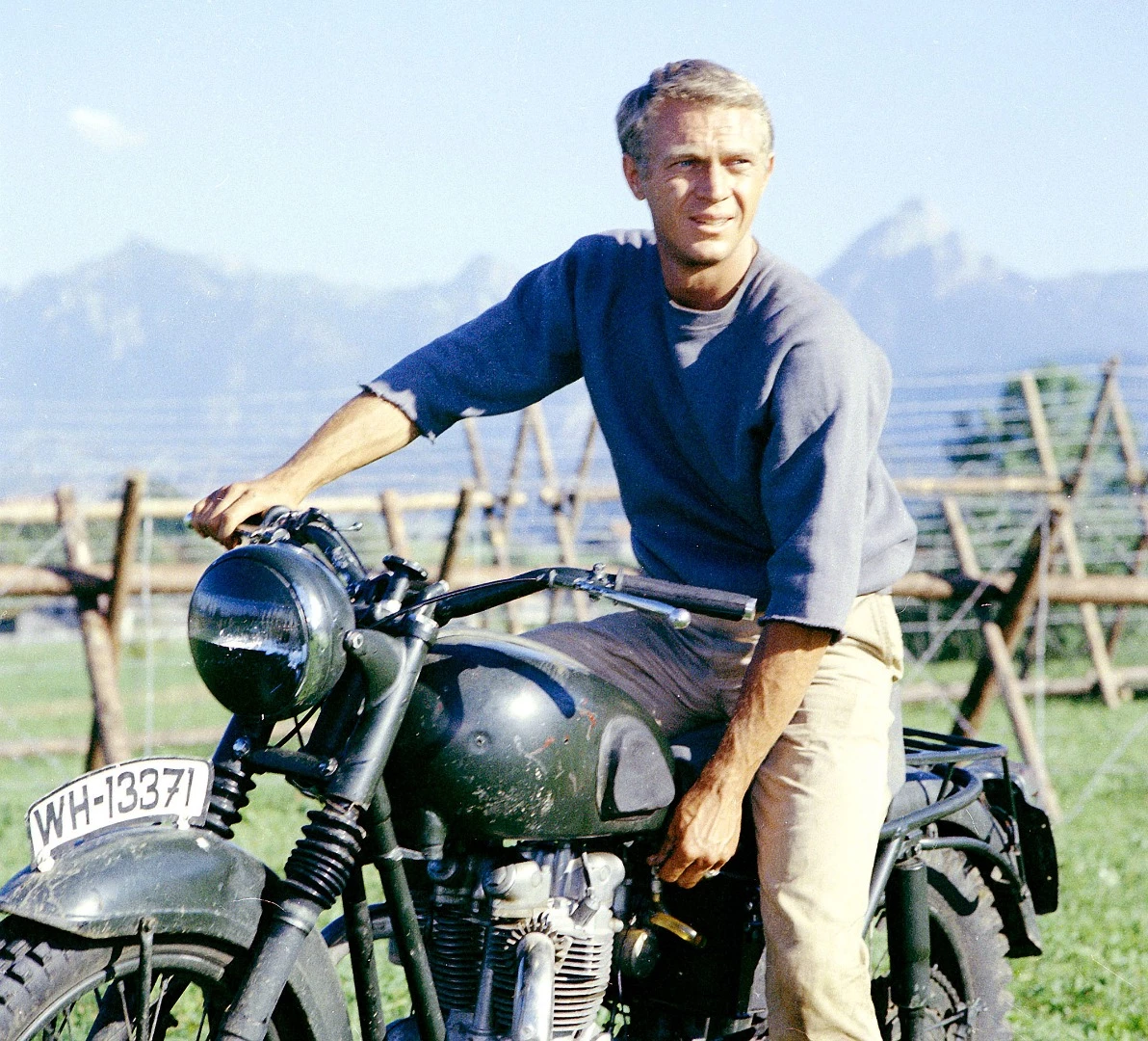 In the film, The Great Escape, Steve McQueen's character jumps a fence on a Triumph TR6 Trophy while being pursued by prison guards. Due to insurance reasons, McQueen wasn't able to perform the main motorcycle stunt in the movie, and the task fell to his great mate Bud Ekins. Bud and his brother Dave Ekins maintain their own web site and the story of what happened is recorded there in Dave's own words.