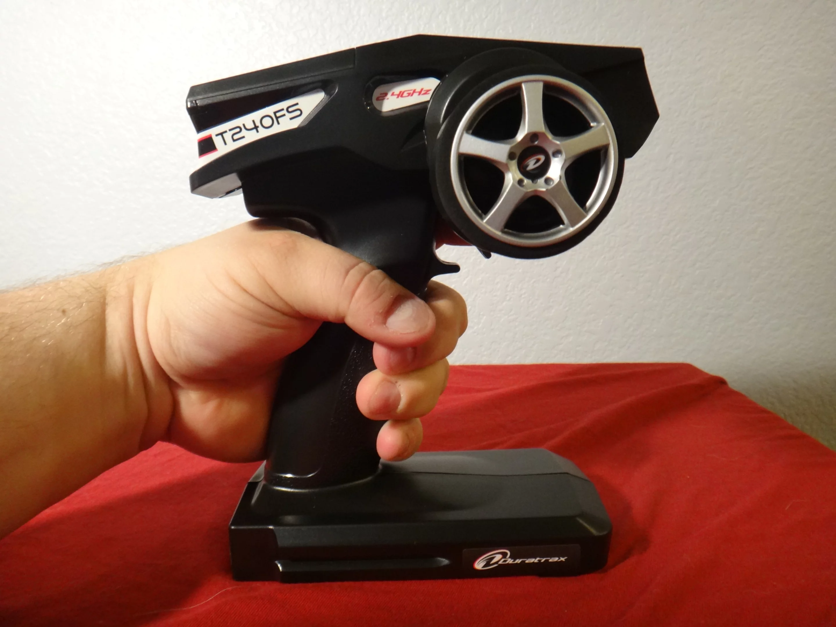 Pulling the trigger drives the car forward and determines its speed by how hard it's pressed, while the turning the wheel on the side steers it