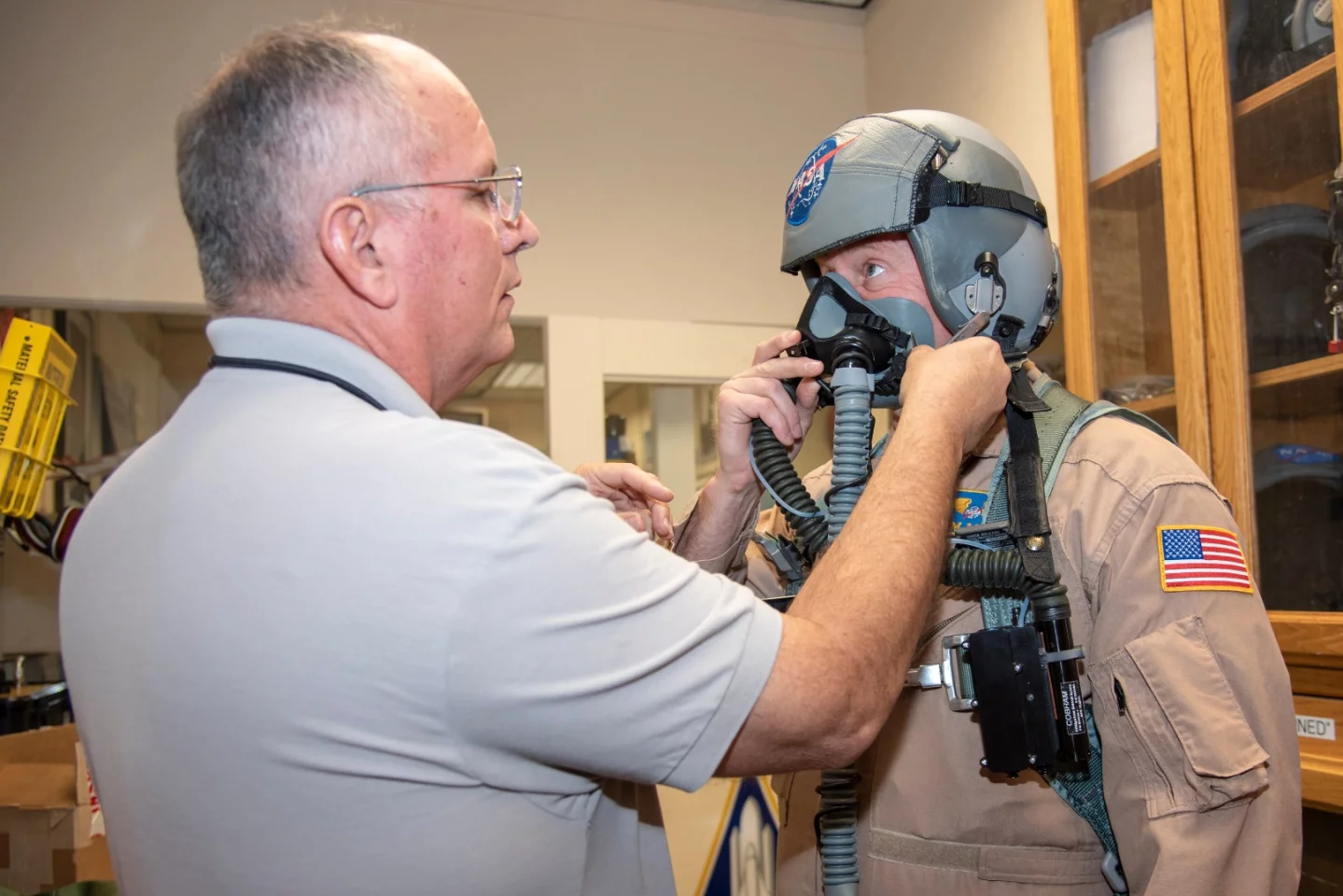 NASA pilot Jim Less is assisted by life support as he is fitted with a Cobham designed VigiLOX pilot oxygen monitoring system