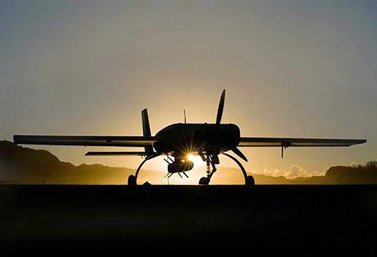 A Cobra UAV stands ready to deliver the Pyros Small Tactical Munition mounted on its drop rail