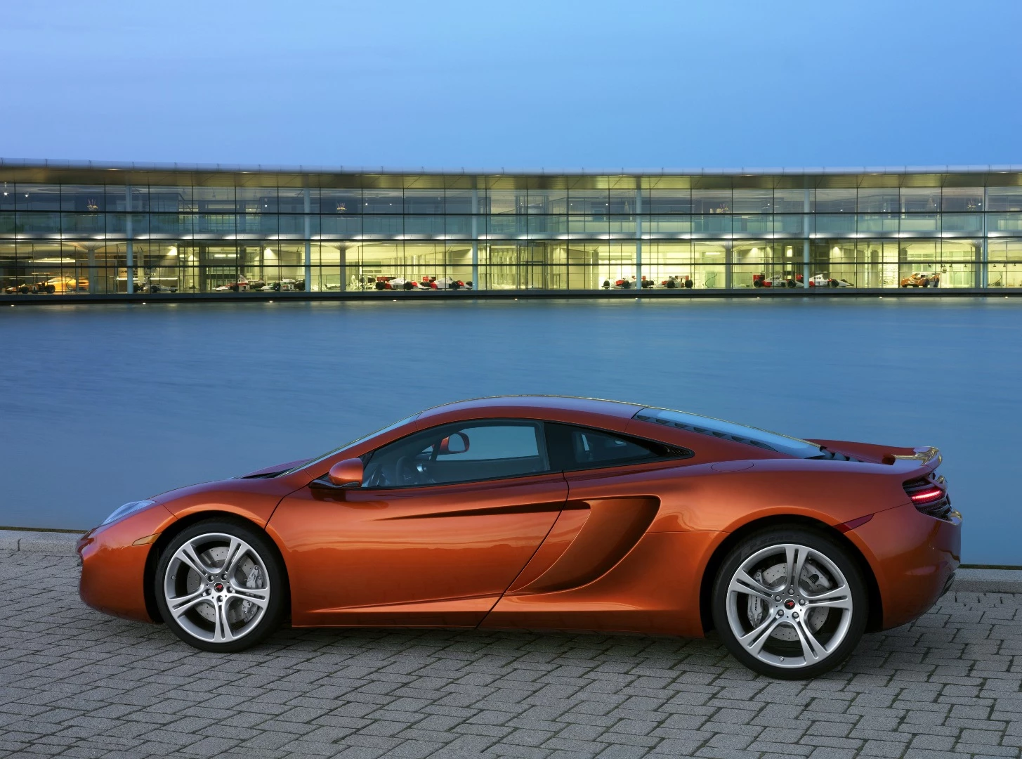 McLaren's first road car since the F1, the MP4-12C, sits next to the lake in Woking