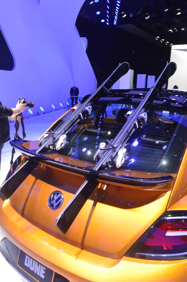 In the rear, skis can be carried on the trunk lid by swiveling the outer portions of the spoiler out of the way, placing the skis beneath those portions, then swiveling them back to hold the skis in place