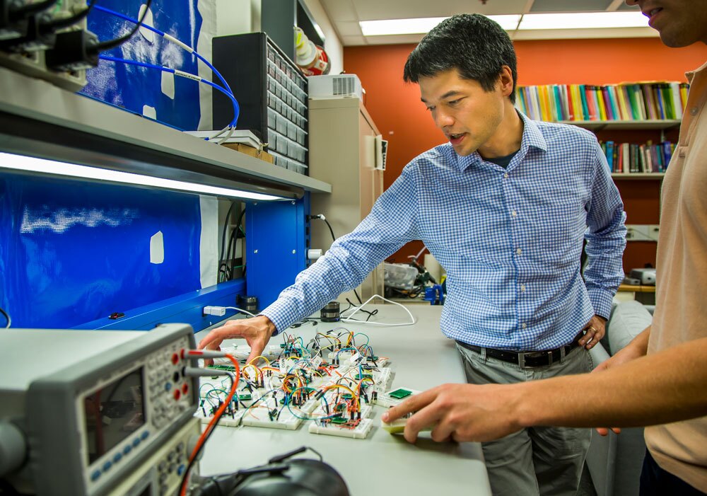 Kevin Fu, associate professor of computer science and engineering, shows how acoustic waves can interfere with the data that certain accelerometer sensors are monitoring