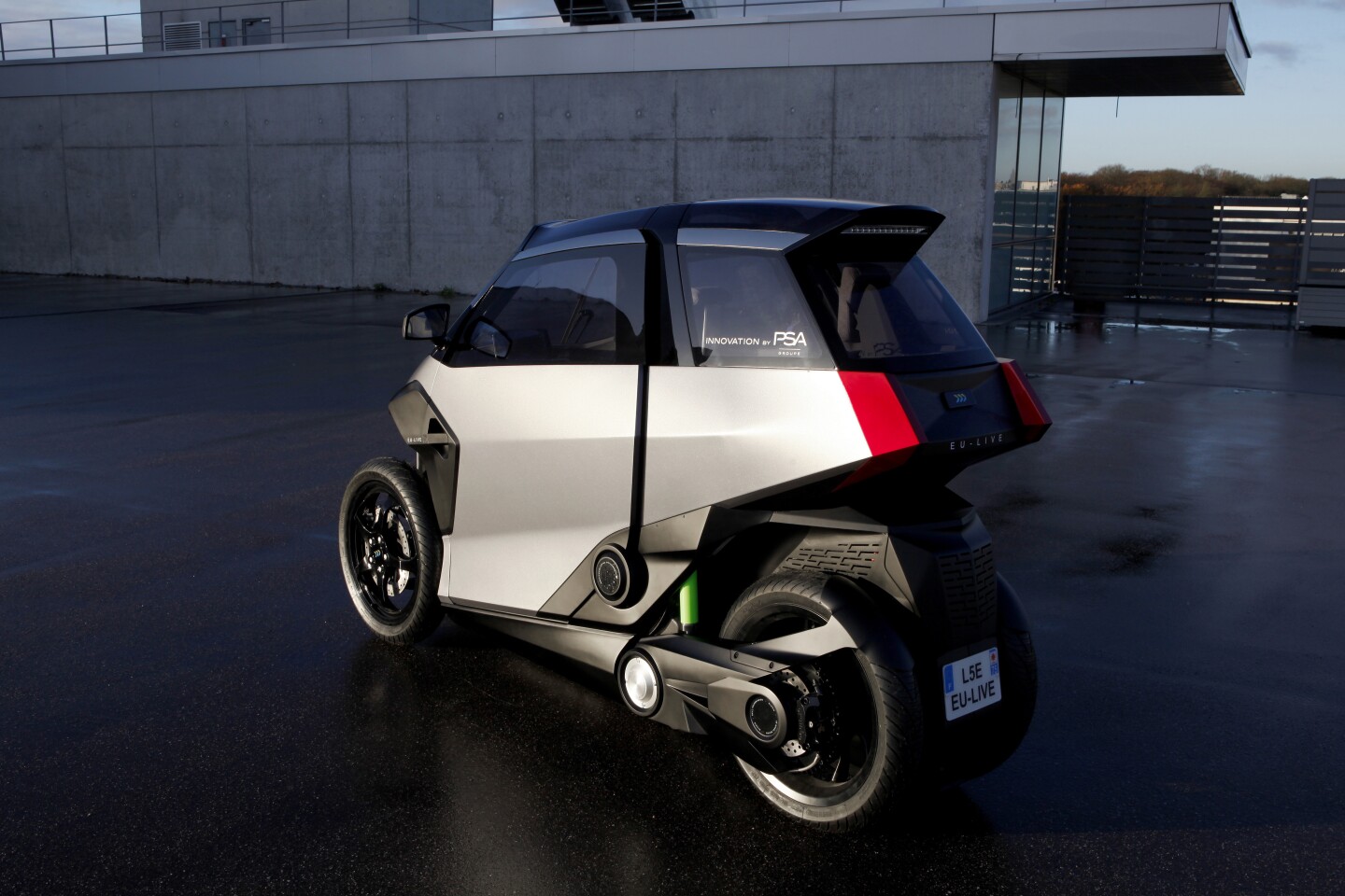 The cabin inside Peugeot's tilting PHEV scooter is heated and features seatbelts and an airbag