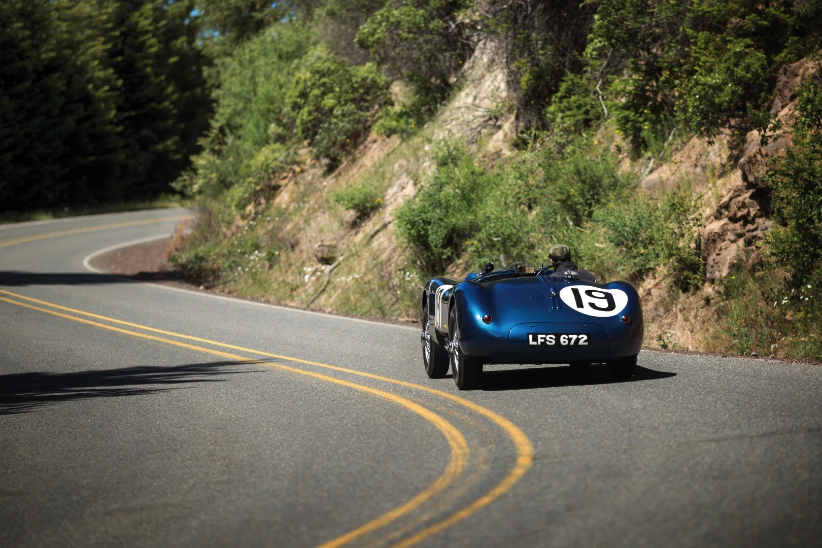 There were just 53 C-Type Jaguars built. Three lightweight works cars (of which this car is one), and a run of 50 cars to satisfy customer demand after the factory cars finished first, second and fourth in the 1953 Le Mans 24 Hour event. The biggest difference to the competition were the disc brakes. Endurance racing was born to demonstrate reliability and validate new automotive technologies for the masses and just as it has done more recently with hybrid and diesel drivetrains, Le Mans heralded the coming of age of a new braking technology with this car and its works siblings. The winning C-type was the first to average more than 100 mph for the 24 Hours of Le Mans (105.8 mph, 170 km/h), and this car, which finished fourth, also broke the ton, averaging 104 mph (167 km/h). Equally at home in any of the world’s finest concours or vintage rallies, this car represents a landmark in Jaguar history.