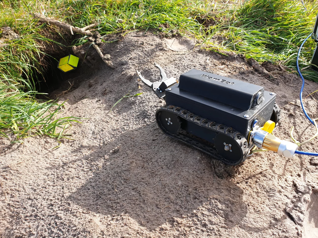 Pictured here approaching a wombat burrow, the WomBot can climb inclines of up to 22 degrees