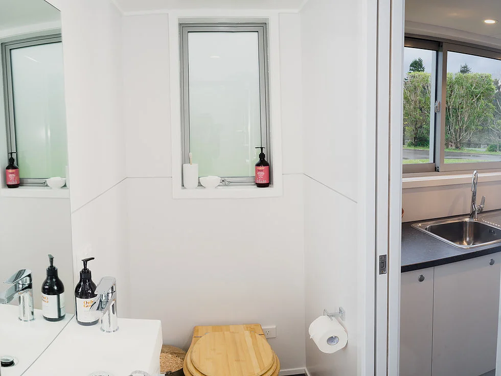 The Buster Tiny House's bathroom includes a composting toilet