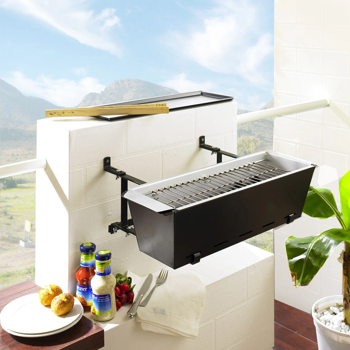 The BBQ Bruce Handrail Grill is a stainless steel grill that can be hung from a regular balcony handrail or even installed on a wall