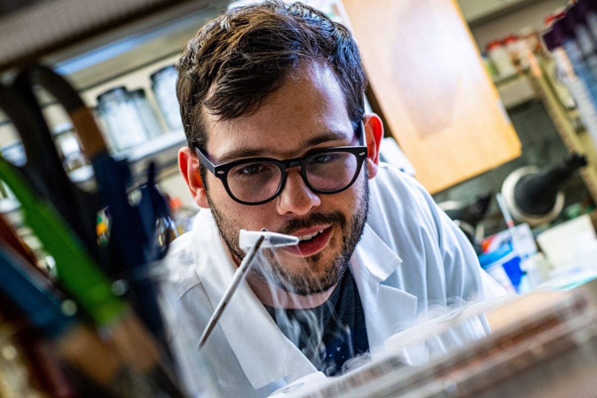 Rice University researcher Ian Campbell, with a vial of ferredoxin proteins