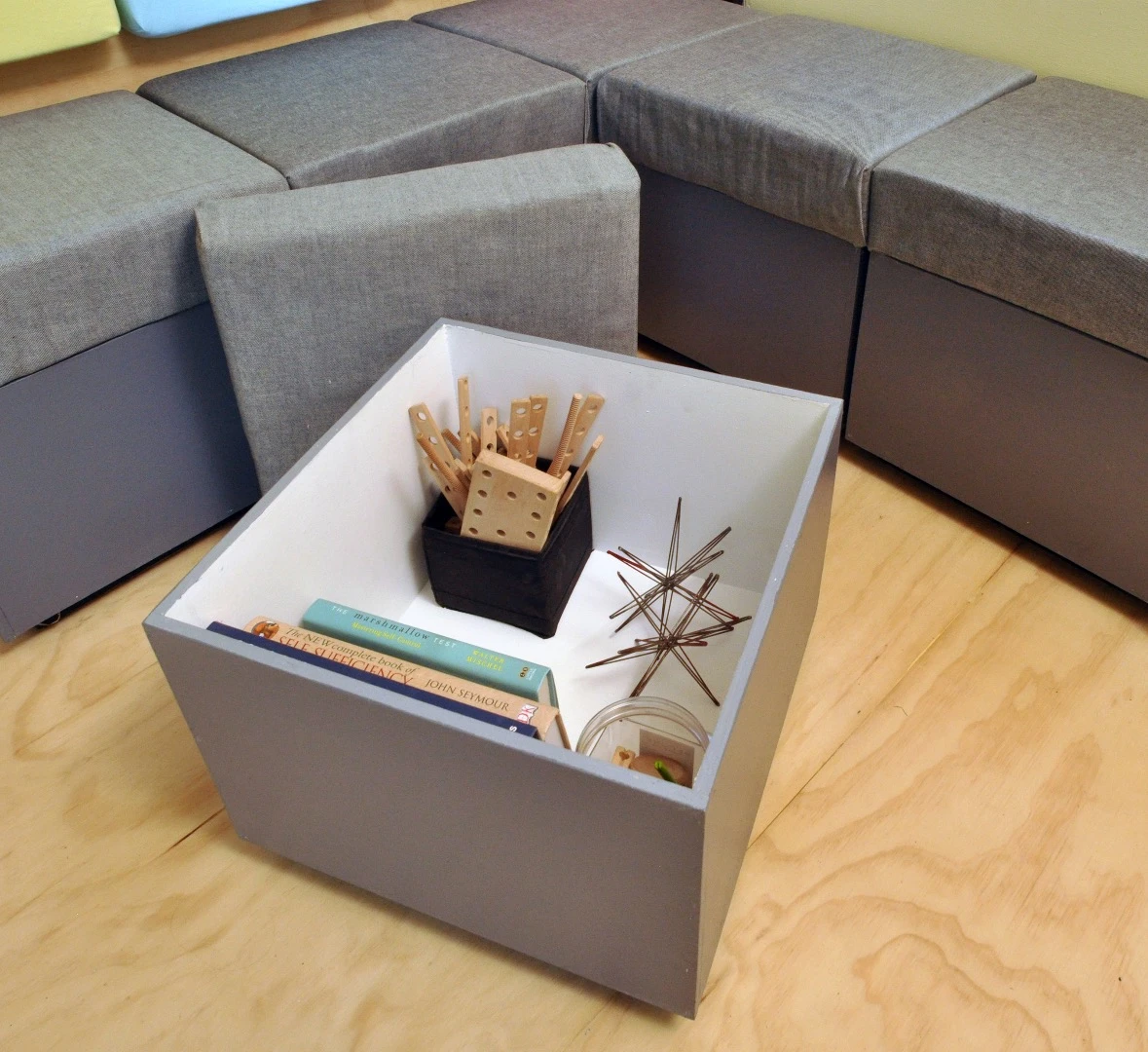 The interior features eight storage cubes which can be arranged to form a couch, several separate seats, or a spare bed, as required