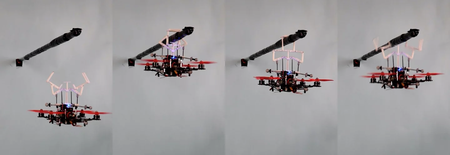 A quadcopter uses the MIP to hang from a horizontal rod