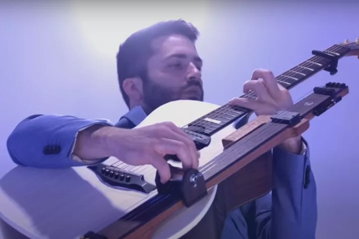 Luca Stricagnoli with the production-ready Reversed Slide Neck mounted to a host acoustic guitar