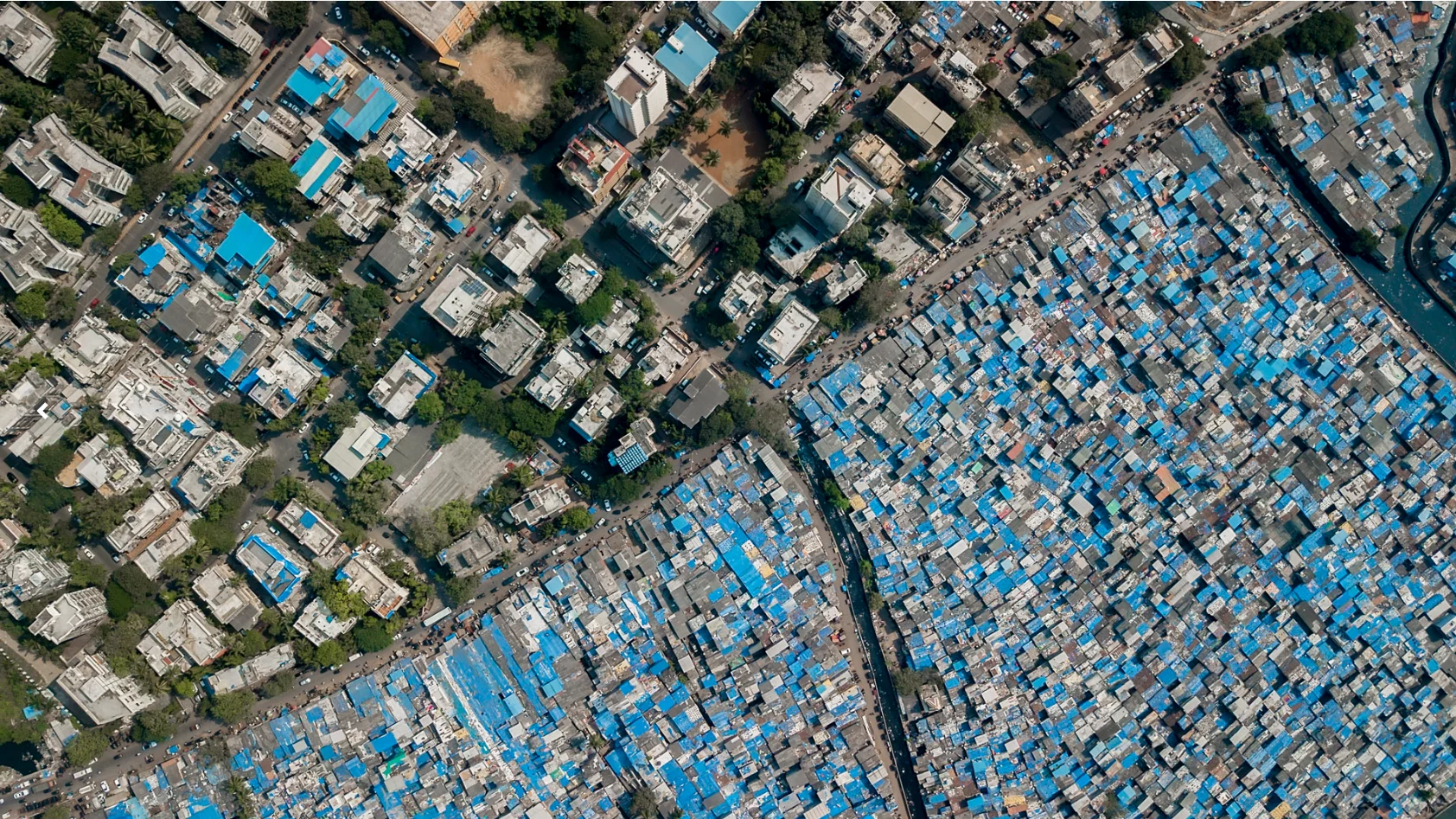 In Mumbai, slum dwellers cover their homes in blue tarp to protect against monsoon rains
