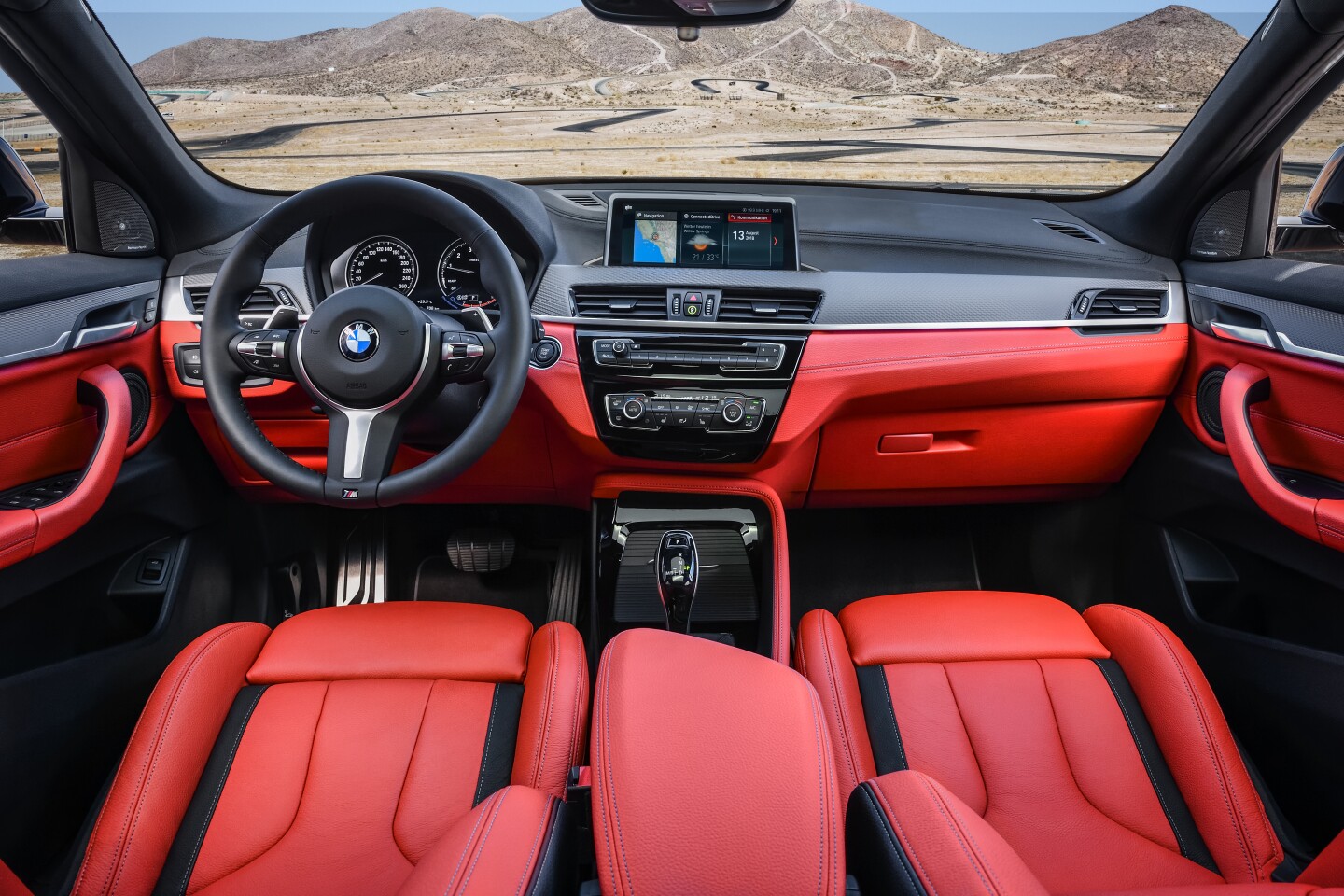 Inside the M35i's cabin there’s an M Sport leather steering wheel with shift paddles and BMW’s iDrive display alongside it
