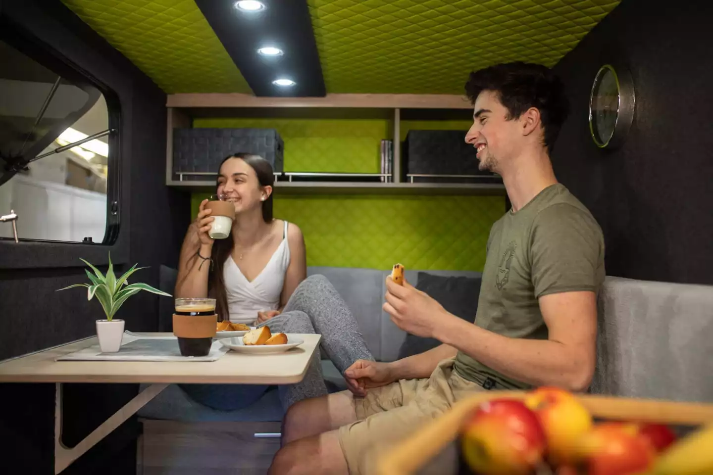 The flip-up table and L-shaped sofa combine to create a lounge for eating, working and relaxing