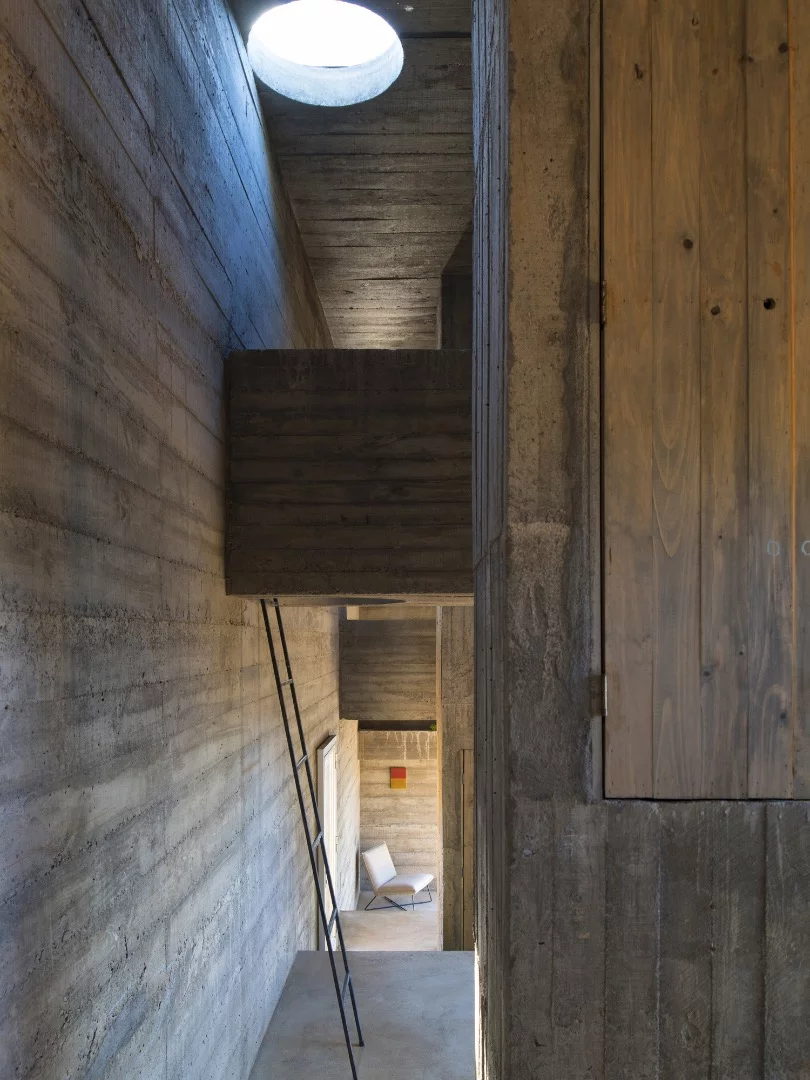Loba House's upper beams contain a small bedroom and desk area