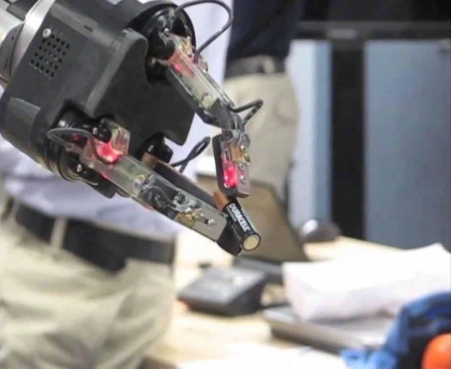 DARPA's ARM program hand easily holds onto a battery