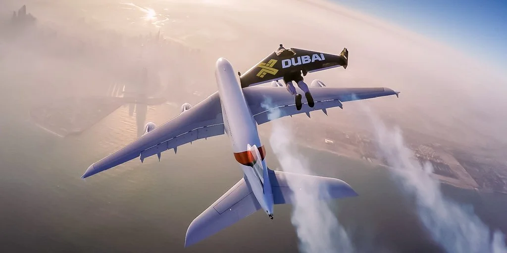 Jetman flies above an Airbus A380 passenger jet in Dubai