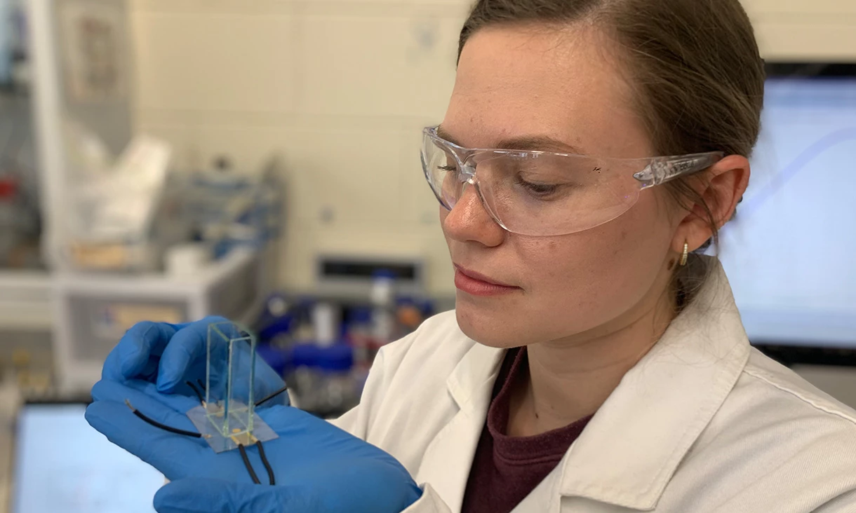 PhD researcher Yemima Ehrnst holding a simple acoustic device used to radically boost hydrogen production during electrolysis