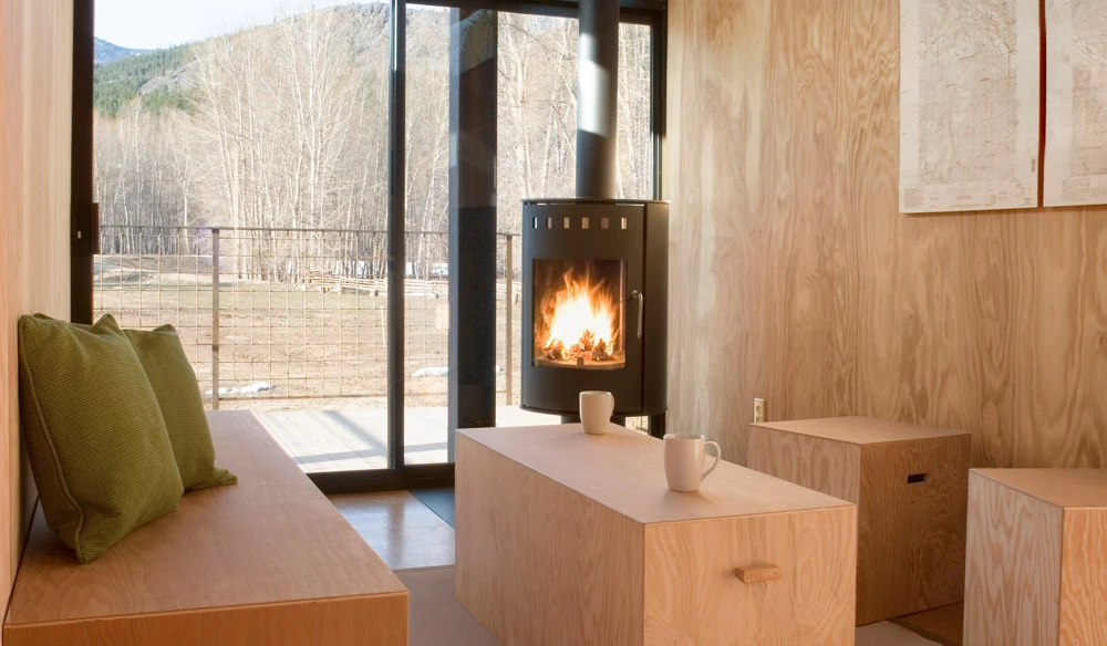 The interior of the huts incorporate an open living space complete with fireplace and minimalist modular furniture
