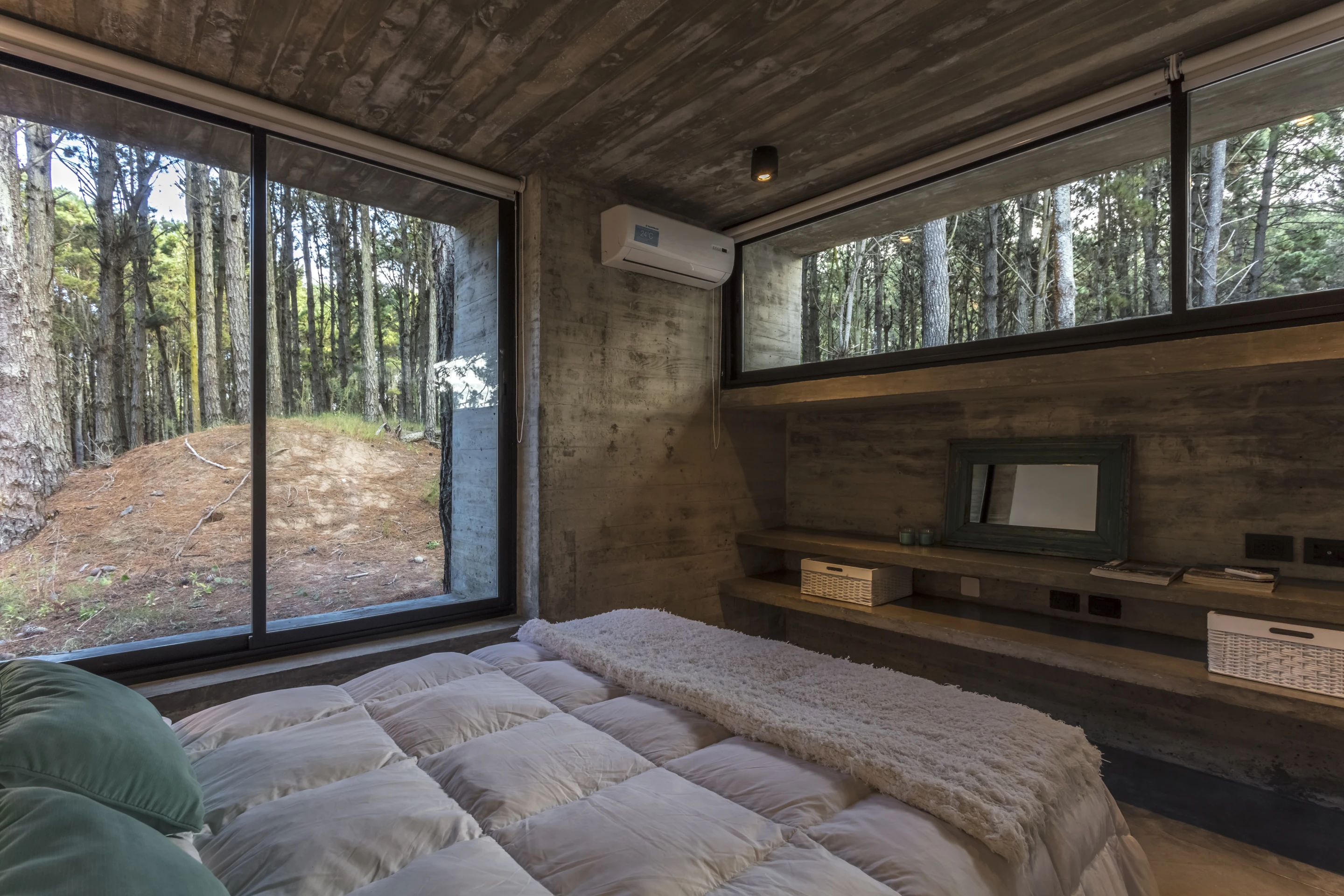 Almost every element of the Forest House is made with concrete, except for the decking, doors, windows, beds, sofas and chairs