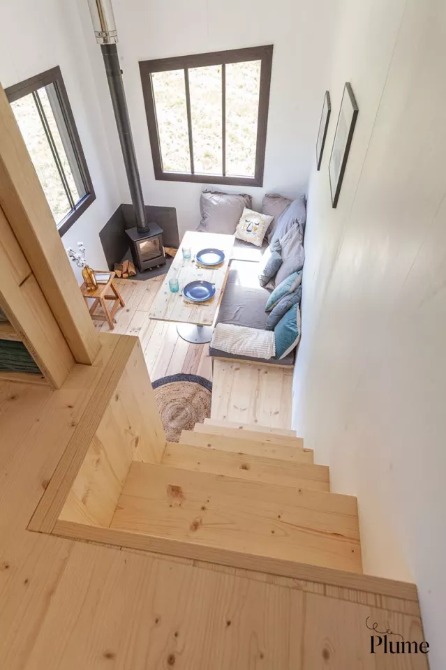 The Courte éclaircie's living room looks light-filled thanks to its generous glazing