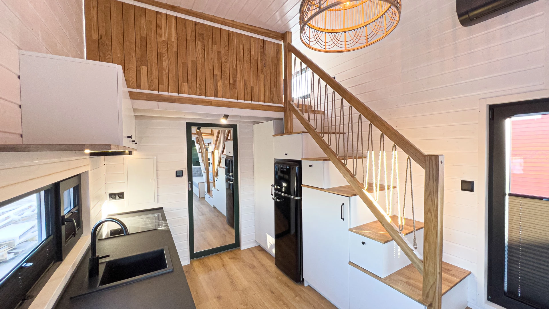 The Mobi Individual Baobab's kitchen connects to its bathroom with a mirrored sliding door