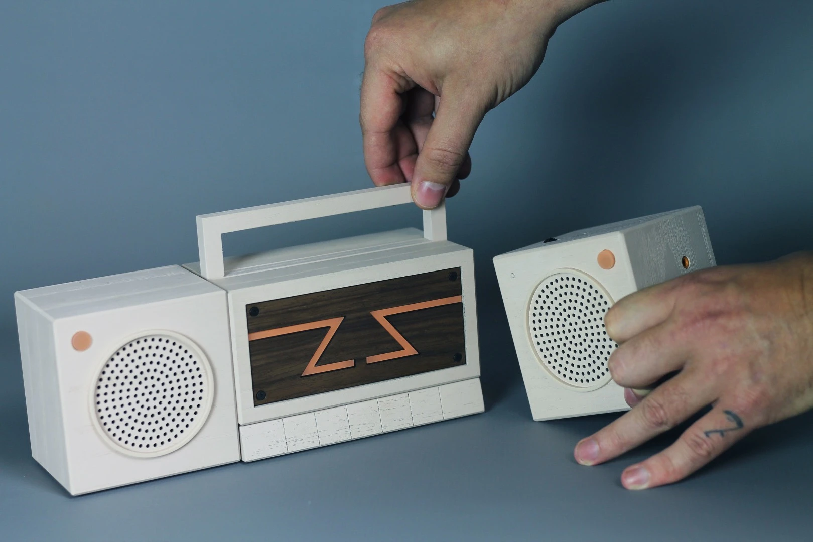 The Zette System is a portable gaming system comprised of several parts that attach together to resemble a 1980s boombox – the middle section contains a projector and two separate controllers