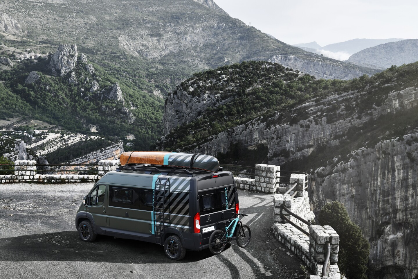 Peugeot Boxer Camper parked on a cliff top road and looking out over the mountains