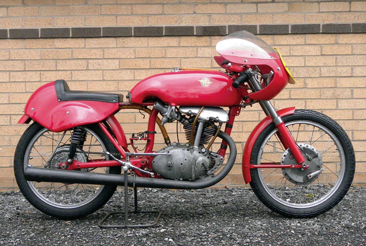 This example of the Ducati 125 Grand Prix was purchased by the vendor in 1980 from a Swiss collector and is pictured in Mick Walkers book "The Ducati Racing Story" on page 44. The bike sold in original condition, described as being "ready to use". The engine has been rebored from its original 55.25 to 58mm which combines with a 52mm stroke to give a displacement of 138cc. An original dustbin fairing and copper seat unit were included with the machine which sold for GBP£77,000 ($125,404) in April, 2011 at H&H Classic auctions Pavilion Gardens sale.