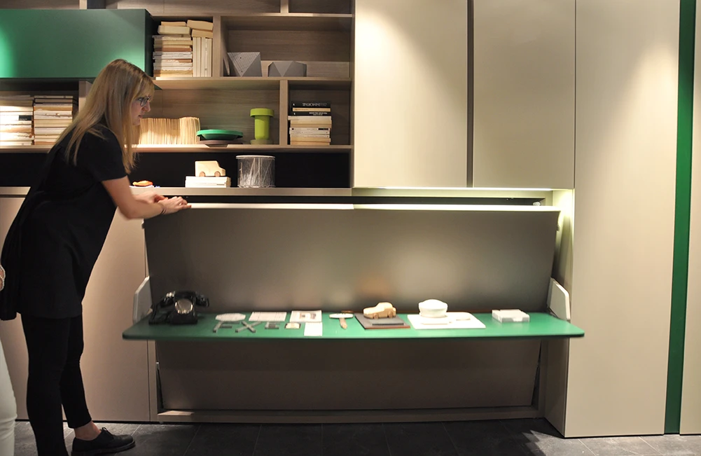 This transformable system features a simple fold-down double bed equipped with a table