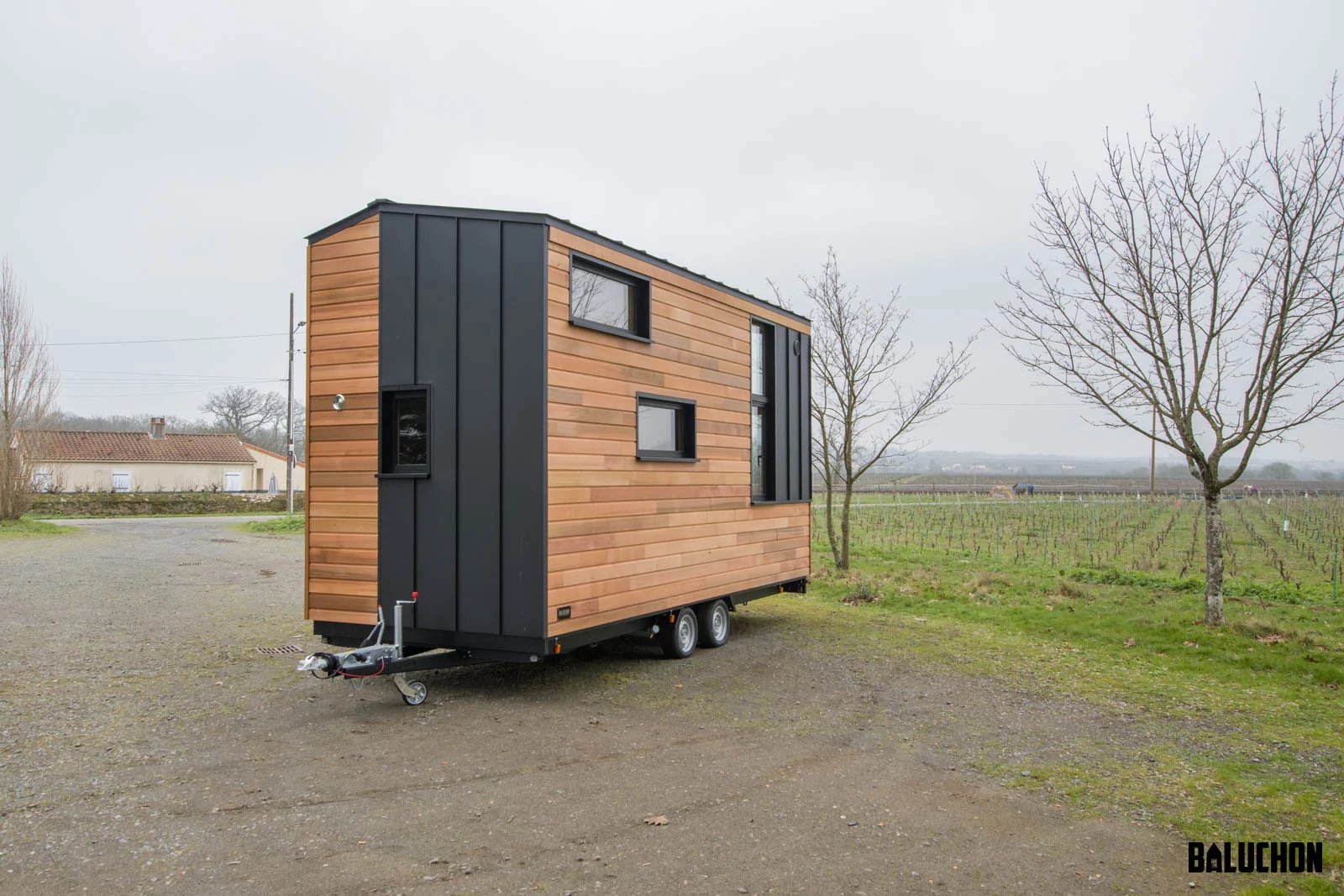 The Kejadenn is finished in red cedar, with black aluminum accenting