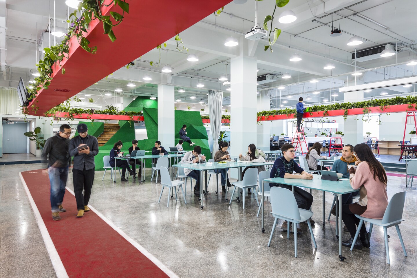 An Office for Social Well-Being: Leping Social Entrepreneur 's kitchen and dining area is ringed by the running track