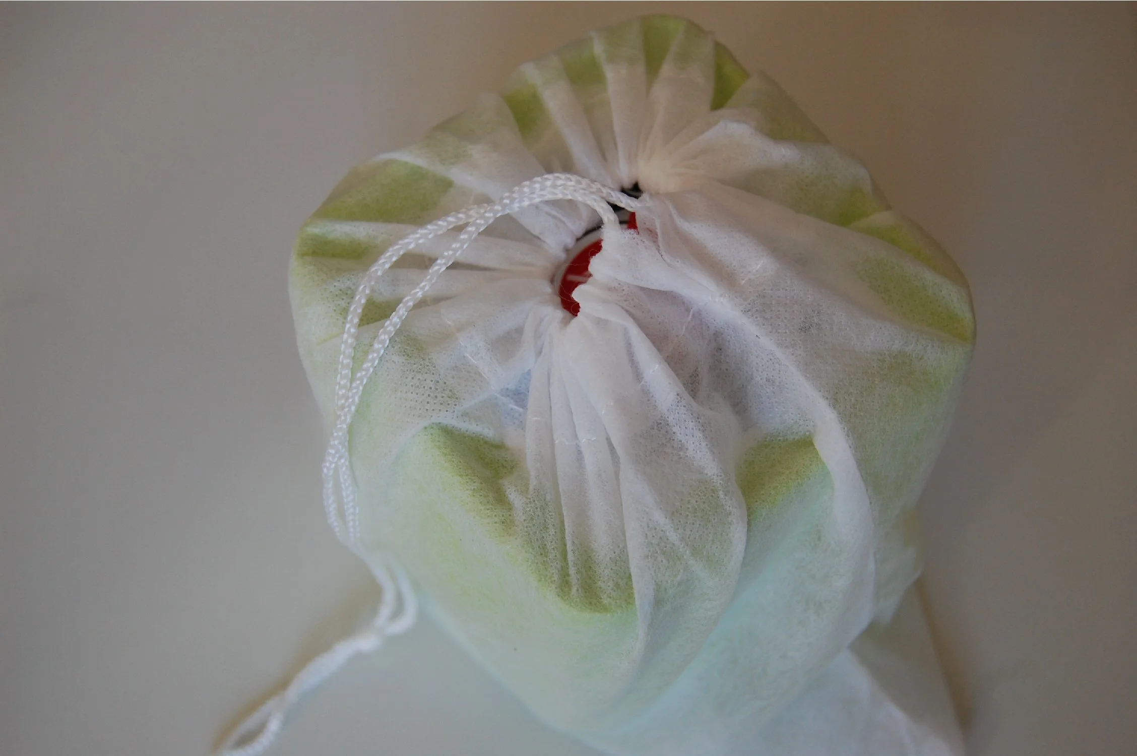 The Q2 is contained within a white cloth bag, useful for keeping it clean when not in use