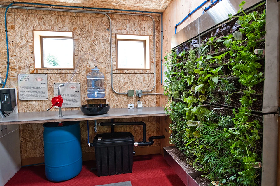 The SEEDclassroom's composting toilet helps to minimize water use, as does the sink in the classroom's Living Laboratory. Its water comes from a water cooler-type transparent bottle, which is refilled by hand pump when empty