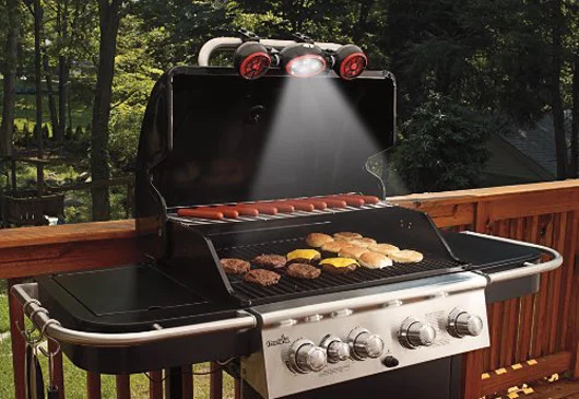 With the BBQ Grill Light and Fan, a lighting unit with four LEDS sits between duals fans to clamp onto the handle of your BBQ