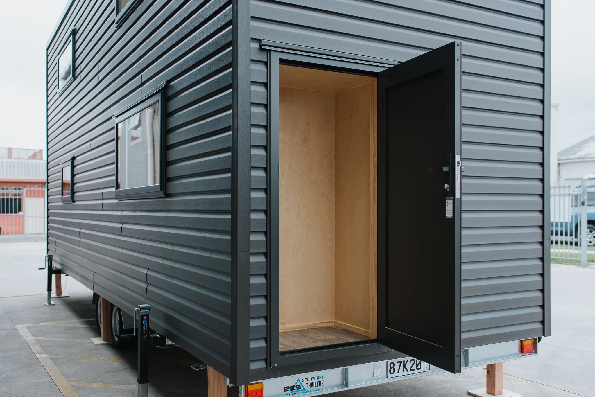 The Kererū Tiny House features an external storage area for off-grid equipment, including batteries