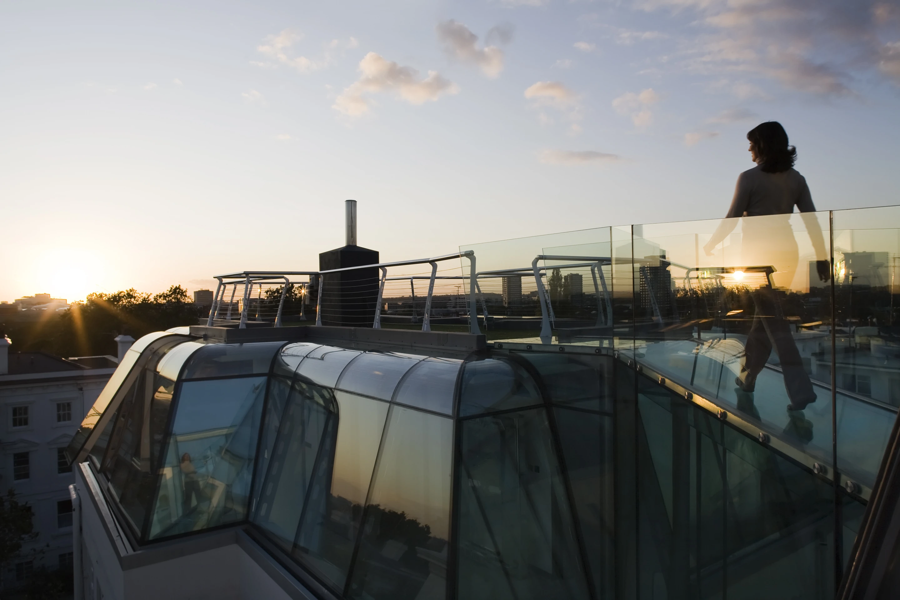 The all-glass home offers stunning views of both the sky at night and the surrounding area