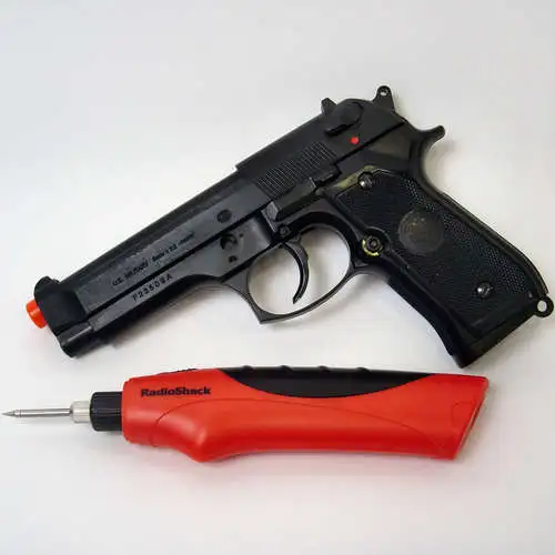 The HFC M9 Spring Airsoft Gun Pistol and RadioShack cordless soldering iron before being dismantled and merged into one