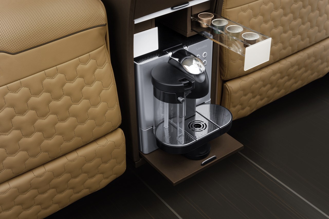 The center console in the passenger cabin includes a coffeemaker