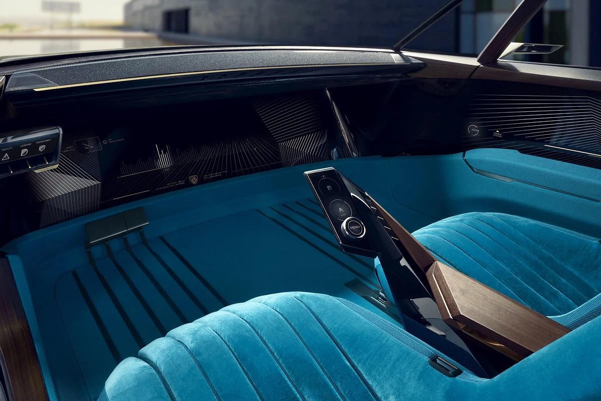 Without the need for a steering wheel, the driver area is all screen