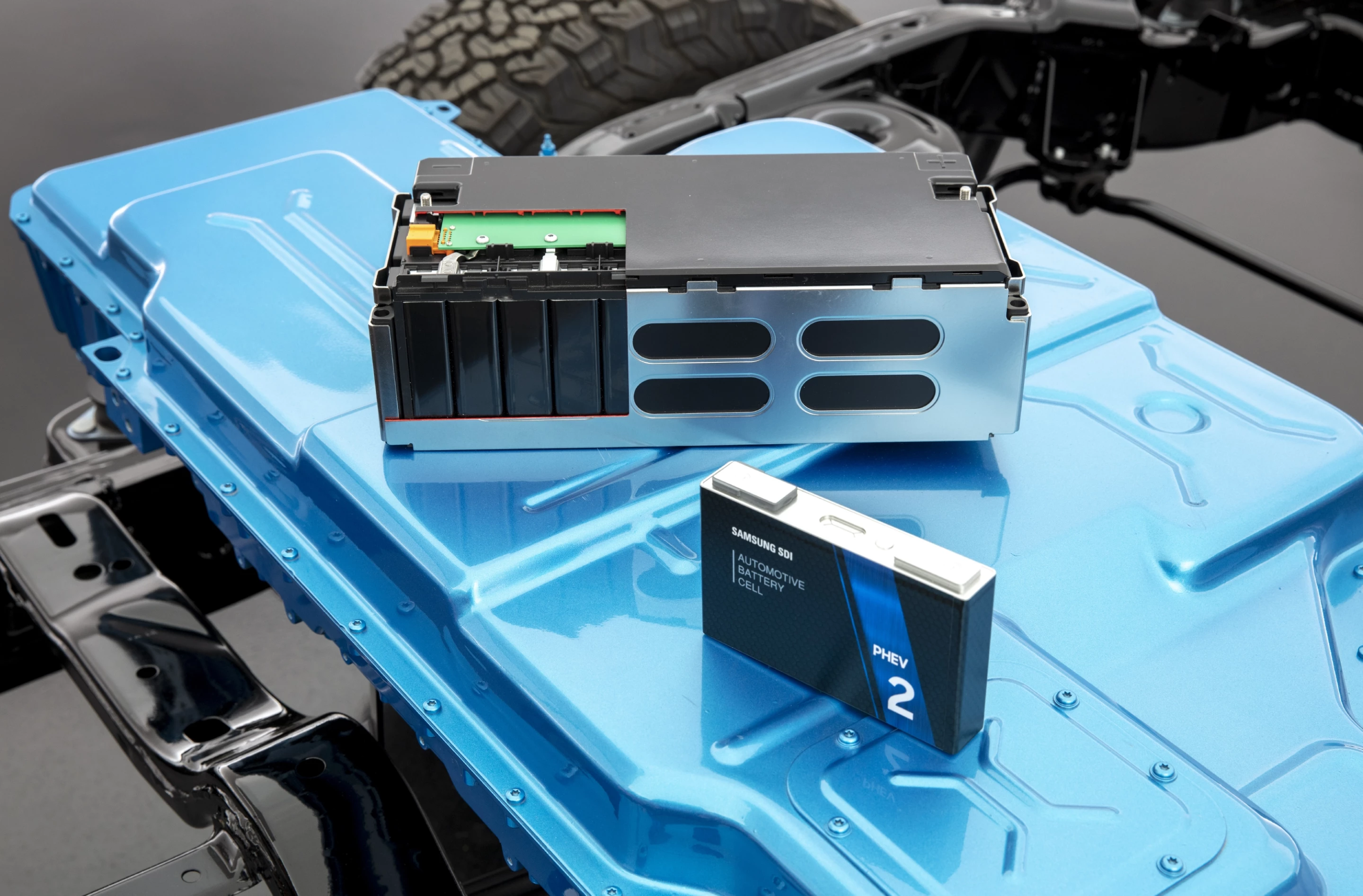 Integrated into the battery pack is the charge controller and power modulator as one unit (top) with one of the 96 battery modules shown for reference