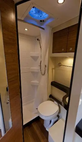The bathroom includes a shower, sink and toilet