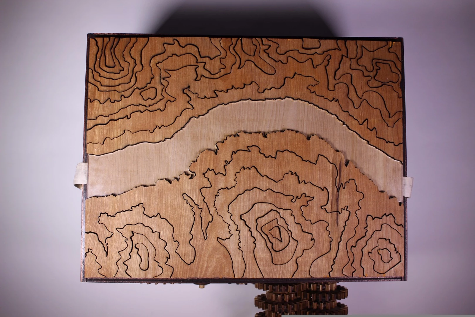 The map starts flat, but turning the hand crank slowly raises patterned sections