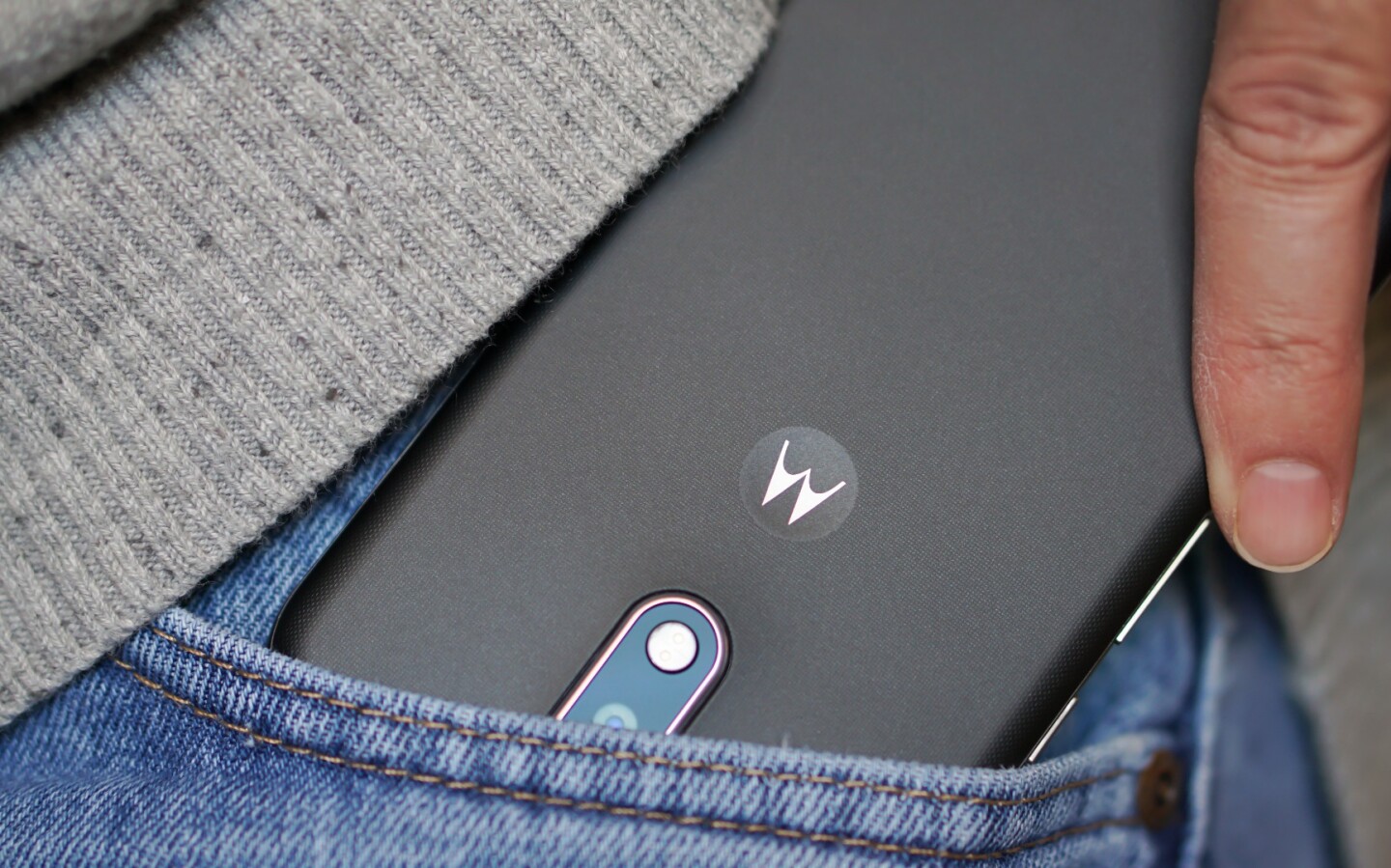 Sliding the Moto G4 into pocket