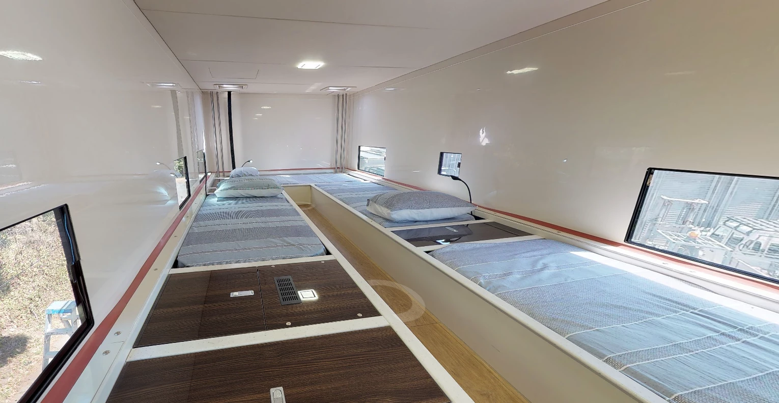 The upstairs bedroom is simple but comfortable with climate control, six beds, storage and a TV